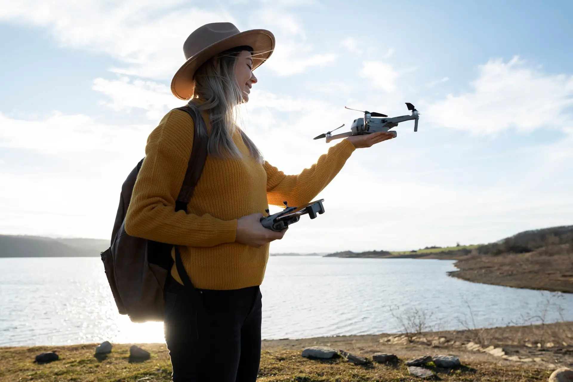 Lady Smiling while Holding a Drone at Smart Drone Academy A female student holding a drone and smiling during hands-on training at Smart Drone Academy.